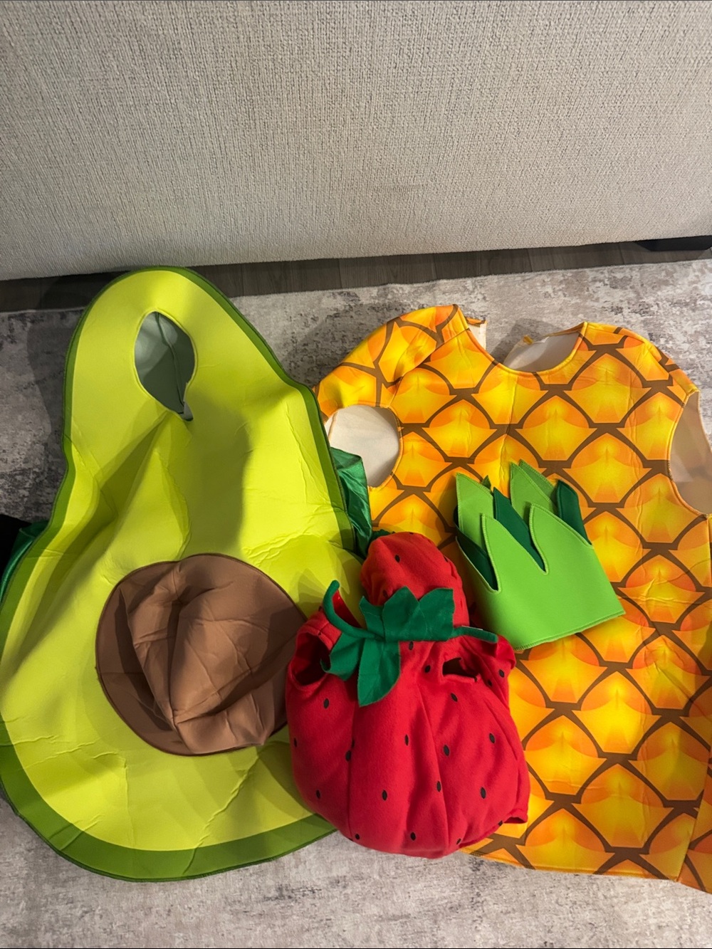 A 3 set costume- adult, pineapple, adult, avocado, and baby strawberry